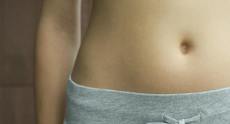 Quali sono le cause del dolore intorno al pulsante del ventre, ed è un segno di gravidanza?